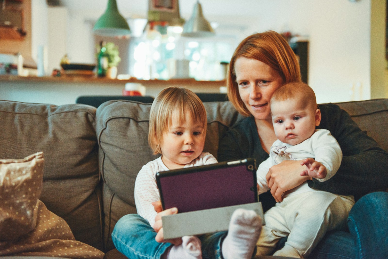 Mother's Day History, Traditions, Language of Flowers, mother with two young children.